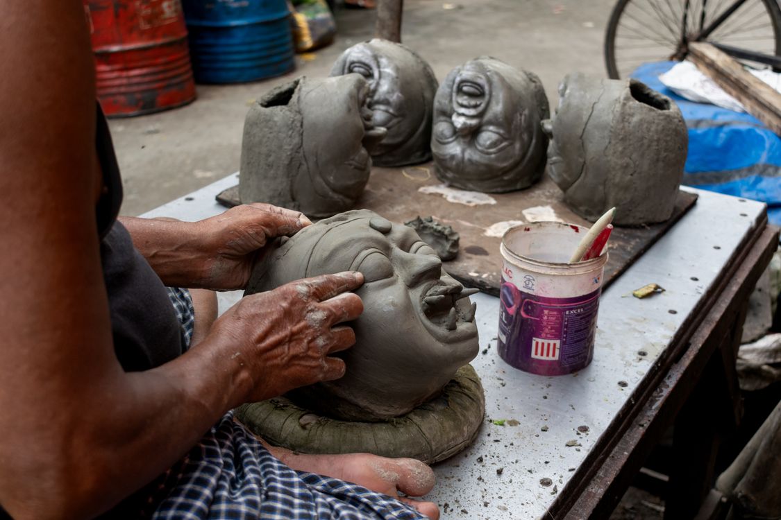 Artisans crafting clay idols in Kumartuli