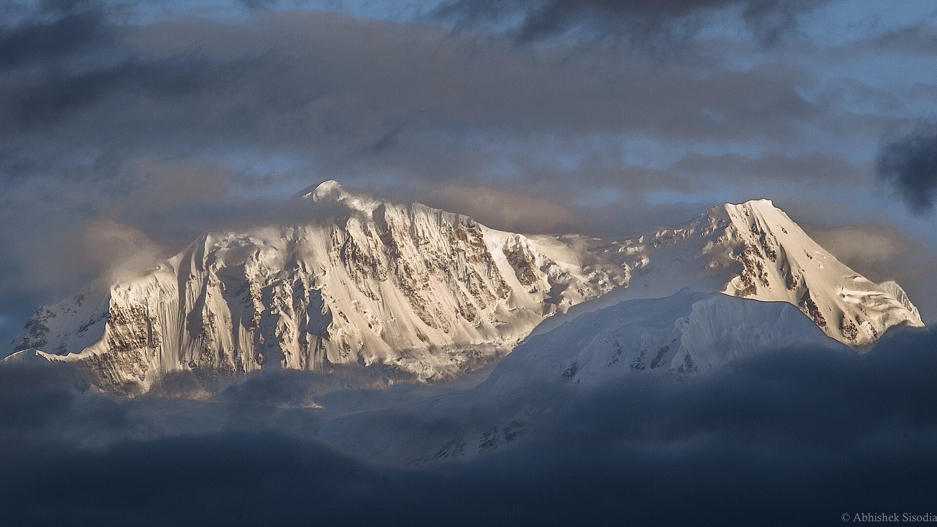 A snow-covered Himalayan peak glowing at sunset in the eastern Himalaya