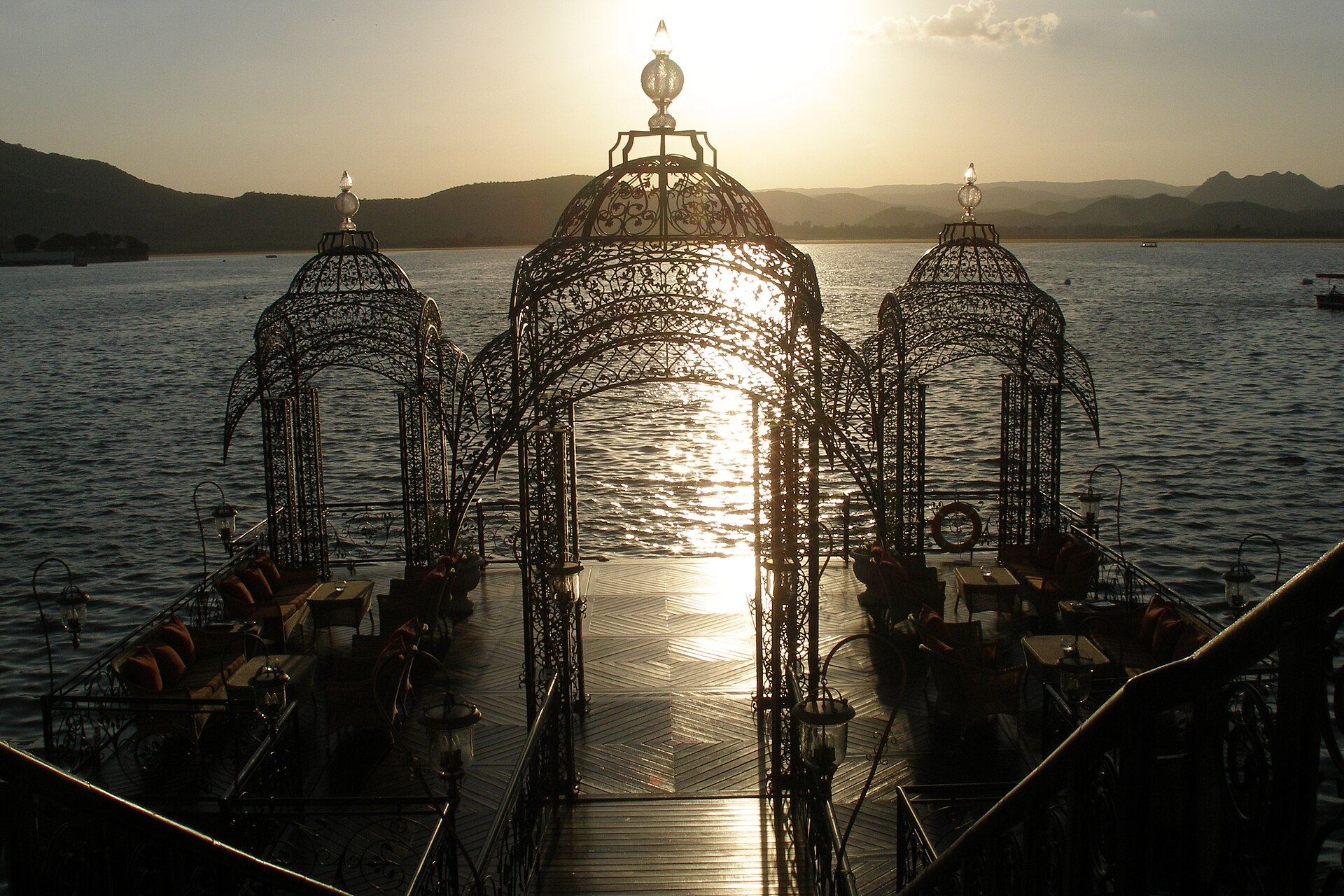 Lantern-lit lakeside terrace at sunset on Lake Pichola, Udaipur