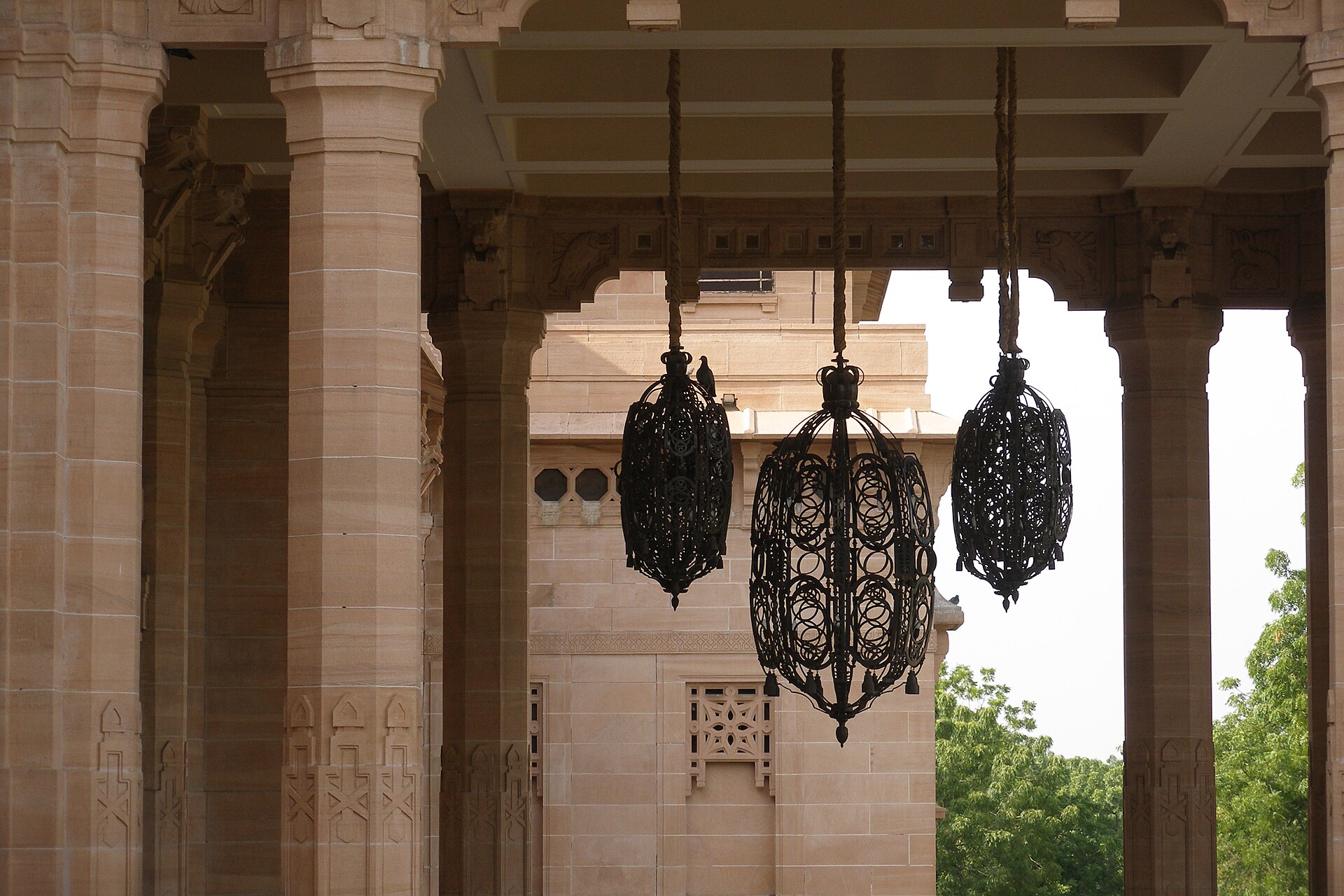 Wrought-iron lanterns among the sandstone columns of Umaid Bhawan Palace, Jodhpur