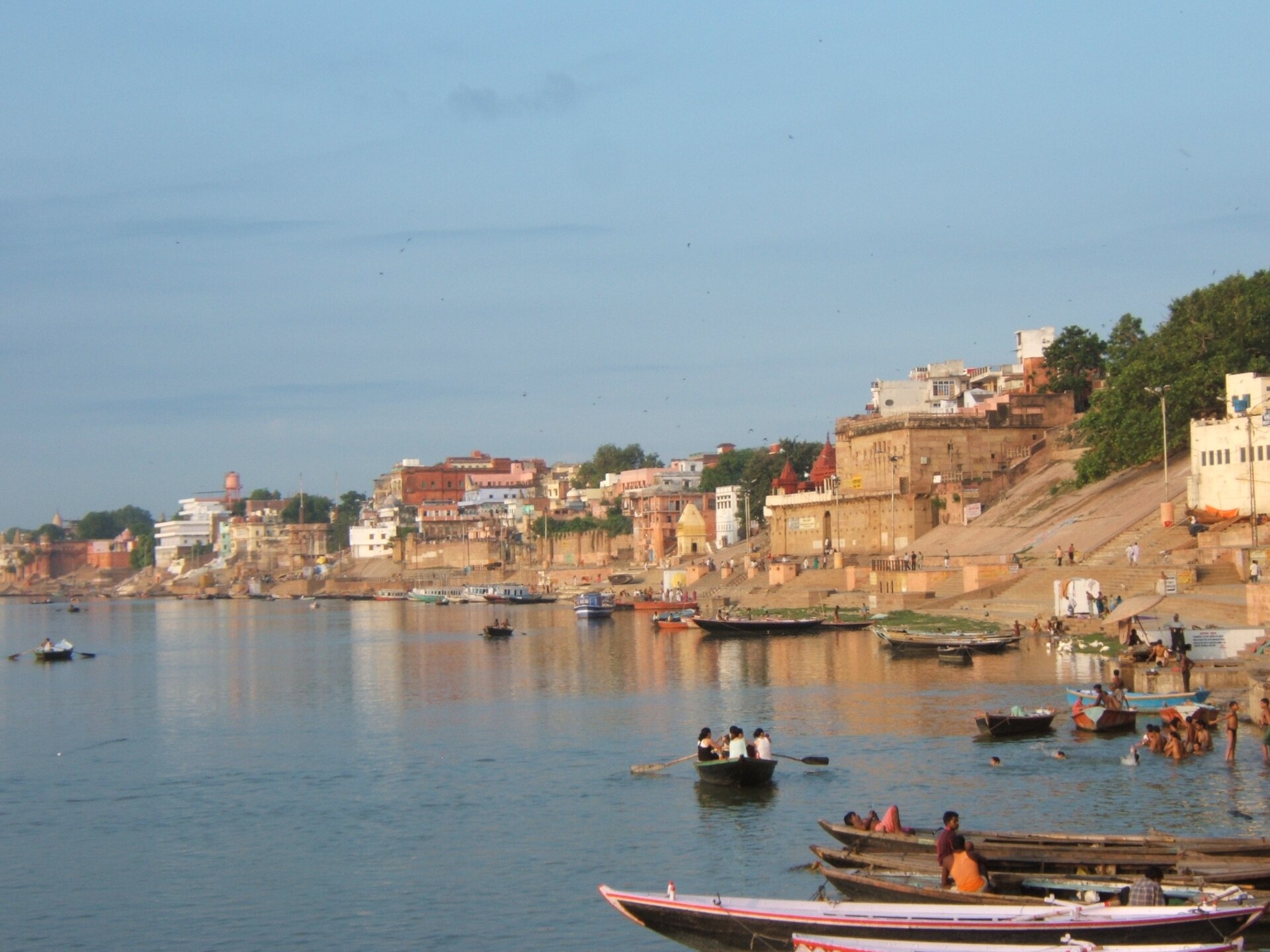 Boats on the Ganges before the ghats of Varanasi at sunrise