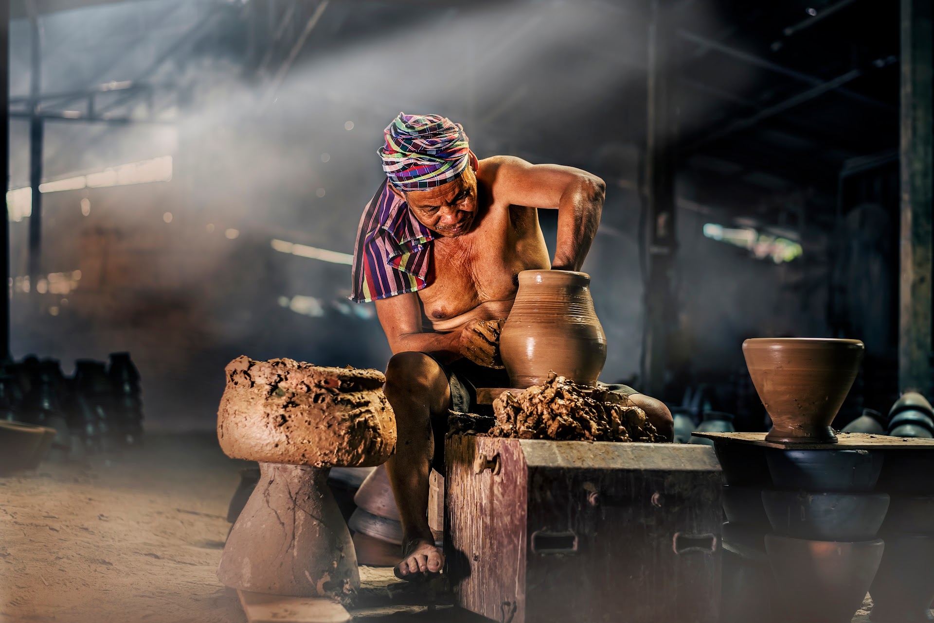 Potter shaping clay on the wheel in a Rajasthan workshop